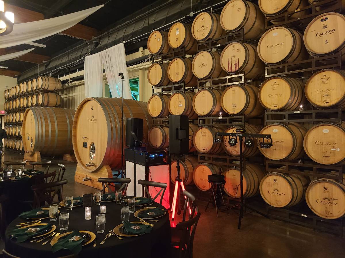 Uplighting and DJ setup at a barrel room venue
